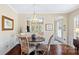 Bright dining area with a wood table set, a stylish chandelier, and access to kitchen at 3008 Sweetleaf Dr, Fort Mill, SC 29707