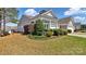 Charming home showcasing a lush lawn, mature landscaping and well-maintained exterior at 3008 Sweetleaf Dr, Fort Mill, SC 29707