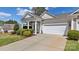 Inviting home exterior with a manicured lawn, a covered porch, and attached two-car garage at 3008 Sweetleaf Dr, Fort Mill, SC 29707