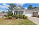 Charming home showcasing a manicured front yard with mature landscaping and inviting covered entry at 3008 Sweetleaf Dr, Fort Mill, SC 29707