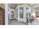 Inviting covered porch features a seating area, neutral paint and large windows at 3008 Sweetleaf Dr, Fort Mill, SC 29707