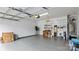 Spacious garage with painted floor, overhead door, storage shelves, and water heater at 3008 Sweetleaf Dr, Fort Mill, SC 29707