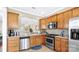 The kitchen features wood cabinets, stainless appliances, tile floors, and a pass through window at 3008 Sweetleaf Dr, Fort Mill, SC 29707