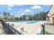 Outdoor community pool with lounging chairs and shaded seating at Sun City Carolina Lakes at 3008 Sweetleaf Dr, Fort Mill, SC 29707