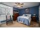 Comfortable primary bedroom with blue walls and a large window at 3248 St Vincent Dr, Claremont, NC 28610