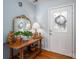 Welcoming foyer features hardwood floors, a decorative table, and a glass-paneled door with detailed trim at 3248 St Vincent Dr, Claremont, NC 28610
