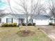 Well-maintained single-Gathering home with mature trees, a two-car garage, and a neatly landscaped front yard at 3248 St Vincent Dr, Claremont, NC 28610