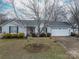 Well-maintained single-Gathering home with mature trees, a two-car garage, and a neatly landscaped front yard at 3248 St Vincent Dr, Claremont, NC 28610