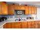 Close up of a kitchen sink and wood cabinetry with a stained glass decoration at 3248 St Vincent Dr, Claremont, NC 28610