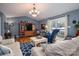Comfortable living room with vaulted ceiling, wood floors, and a sliding door leading to a deck at 3248 St Vincent Dr, Claremont, NC 28610