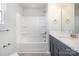 Bright bathroom featuring a tub/shower combination with white tile surround, dark vanity and modern fixtures at 330 Malvern Sw Ave # A, Concord, NC 28025