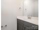 Elegant half-bathroom with granite countertop, modern fixtures, and a stylish towel rack at 330 Malvern Sw Ave # A, Concord, NC 28025