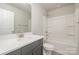 Bathroom featuring a shower-tub combo with gray vanity and solid surface countertop at 330 Malvern Sw Ave # A, Concord, NC 28025