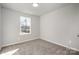 A well-lit, carpeted bedroom featuring a large window providing ample natural light at 330 Malvern Sw Ave # A, Concord, NC 28025