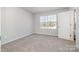 Bedroom featuring a large window and neutral-toned carpet at 330 Malvern Sw Ave # A, Concord, NC 28025