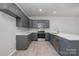 Modern kitchen featuring stainless steel appliances, gray cabinetry, and a spacious countertop at 330 Malvern Sw Ave # A, Concord, NC 28025