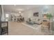 Open-concept living space with hardwood floors, modern furniture, and kitchen view at 330 Malvern Sw Ave # A, Concord, NC 28025