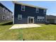 Back patio with sliding glass doors and verdant grass, great for entertaining outdoors at 334 Knotty Wood Dr # 68, Monroe, NC 28110