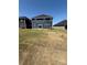 View of the backyard with a sliding glass door leading into the home at 334 Knotty Wood Dr # 68, Monroe, NC 28110