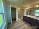 Modern bathroom featuring a double vanity, glass shower, and linen closet at 334 Knotty Wood Dr # 68, Monroe, NC 28110