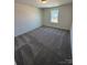 Bedroom featuring a window that provides plenty of natural light to fill this room and neutral carpeting at 334 Knotty Wood Dr # 68, Monroe, NC 28110