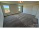 This carpeted bedroom includes two windows for natural light and a closet for storage at 334 Knotty Wood Dr # 68, Monroe, NC 28110
