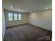Bedroom featuring neutral paint, carpet flooring, and three windows at 334 Knotty Wood Dr # 68, Monroe, NC 28110