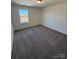 Bedroom filled with neutral-toned carpeting and a window allowing for ample natural light to fill this space at 334 Knotty Wood Dr # 68, Monroe, NC 28110