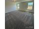 Spacious bedroom with soft, neutral-toned carpeting and two windows for plenty of natural light at 334 Knotty Wood Dr # 68, Monroe, NC 28110