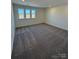 Bright bedroom featuring three windows allowing for ample natural light and neutral carpeting at 334 Knotty Wood Dr # 68, Monroe, NC 28110