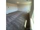 Bonus room filled with neutral carpeting and a window allowing natural light to brighten the space at 334 Knotty Wood Dr # 68, Monroe, NC 28110