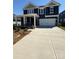 Two-story home features a concrete driveway leading to a spacious two-car garage, offering ample parking at 334 Knotty Wood Dr # 68, Monroe, NC 28110