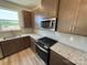 Galley kitchen featuring stainless steel appliances, granite countertops, and modern cabinets at 334 Knotty Wood Dr # 68, Monroe, NC 28110