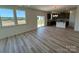 Open concept living area featuring lots of windows, hardwood floors, and neutral paint at 334 Knotty Wood Dr # 68, Monroe, NC 28110