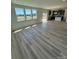 Bright and airy open-concept living room with luxury vinyl flooring and expansive windows at 334 Knotty Wood Dr # 68, Monroe, NC 28110