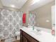 Bright bathroom featuring a vanity with dark cabinets, a patterned shower curtain, and a large mirror at 446 Clouds Way Way, Rock Hill, SC 29732
