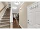 Bright entryway featuring stairs, a coat rack, and a glimpse into the beautifully decorated living space at 446 Clouds Way Way, Rock Hill, SC 29732