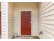 A close up of the red front door, siding and a 'Dogs Welcome' door mat at 446 Clouds Way Way, Rock Hill, SC 29732