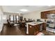 Open-concept kitchen and living area with rich wood floors and modern appliances at 446 Clouds Way Way, Rock Hill, SC 29732