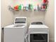 Functional laundry room with a full-size washer and dryer and extra storage at 446 Clouds Way Way, Rock Hill, SC 29732