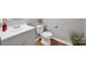 Bathroom with gray vanity, white countertop, modern fixtures, and wood look floors at 4708 Tradd Cir, Monroe, NC 28110