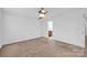 Neutral bedroom with ceiling fan and doorway to bathroom is ready for your personal touches at 4708 Tradd Cir, Monroe, NC 28110
