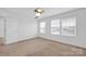 Bright bedroom features large windows, neutral carpet, and a ceiling fan for year-round comfort at 4708 Tradd Cir, Monroe, NC 28110