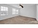 Neutral carpeted bedroom with three windows providing plenty of natural light at 4708 Tradd Cir, Monroe, NC 28110