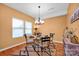 Dining room with a glass table, designer lighting, and light-filled windows at 4708 Tradd Cir, Monroe, NC 28110