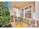 Charming front porch featuring decorative bistro table, chairs, and bright yellow rug at 4708 Tradd Cir, Monroe, NC 28110