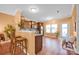An open kitchen features stainless steel appliances and a breakfast bar with wood floors at 4708 Tradd Cir, Monroe, NC 28110
