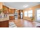 A bright kitchen showcases stainless steel appliances, wood cabinets, and wood floors at 4708 Tradd Cir, Monroe, NC 28110
