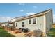 Exterior of home features a patio with fire pit, comfortable seating and lush green lawn at 50143 Robins Nest Ln, Lancaster, SC 29720
