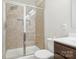 Bathroom with a modern glass-enclosed shower and dark wood vanity, blending functionality with contemporary design at 50143 Robins Nest Ln, Lancaster, SC 29720
